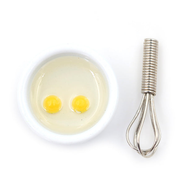 Miniature Cracked Eggs in Bowl with Whisk