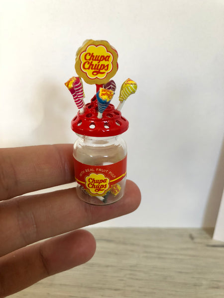 Miniature Chupa Chups on finger